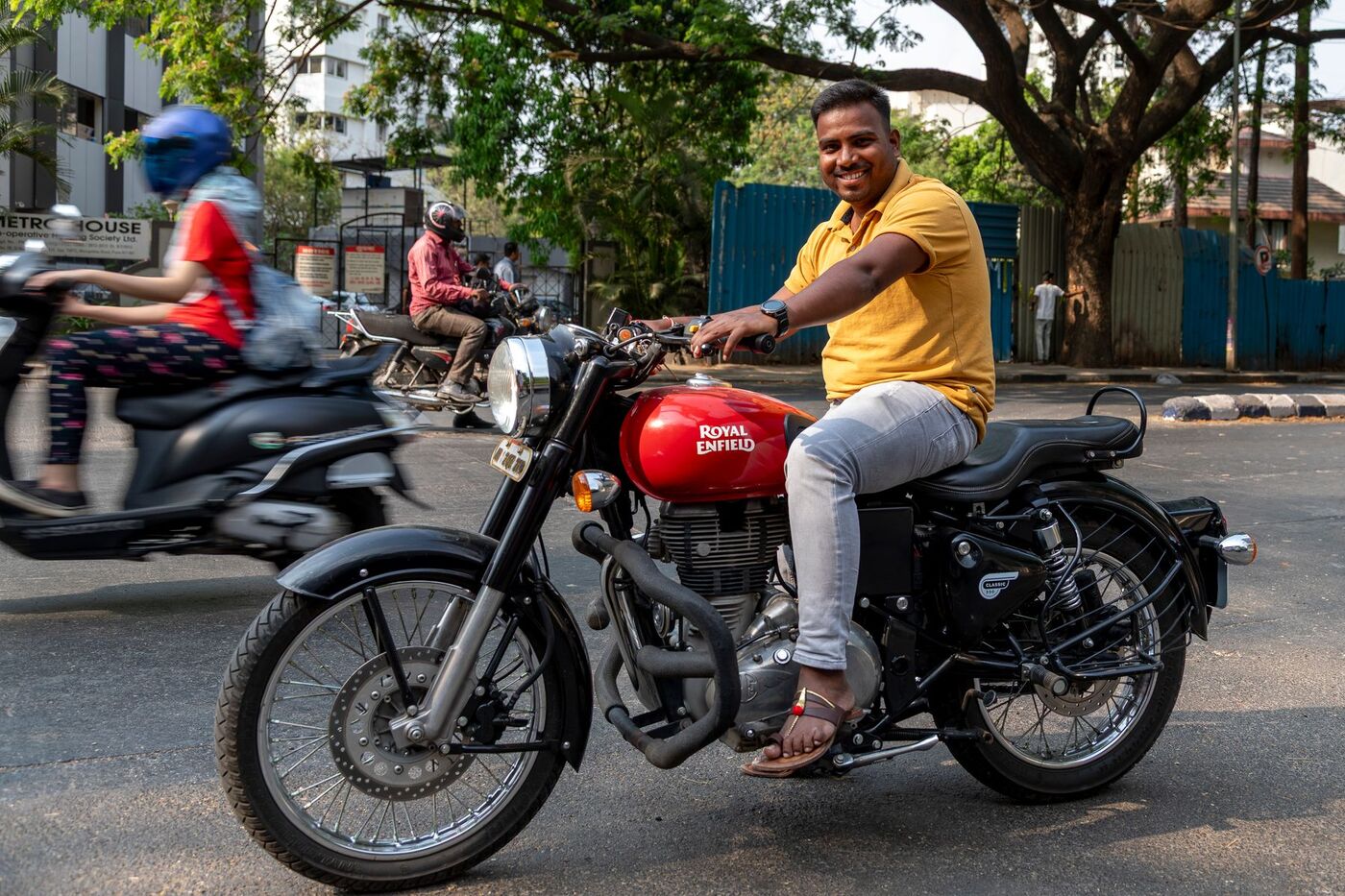 Smiling rider on a Royal Enfield Classic 350, one of the bikes you can rent at Bike Land